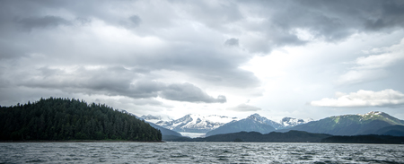 abstract cloudy waterscape AND MOUNTAIN RANGE IN ALASKAの写真素材