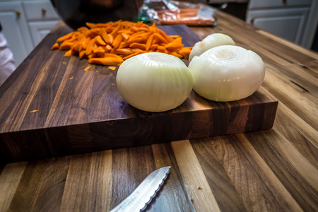 butcher block cutting board with vegetablesの写真素材