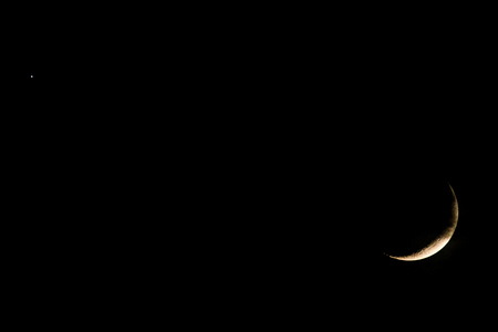 new moon on dark skyの写真素材