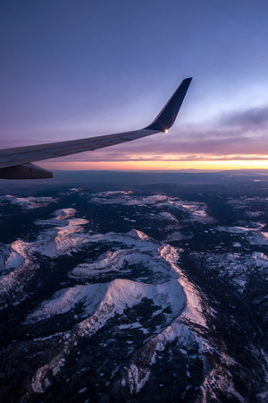 Flying over colorado rocky mountains at sunsetの写真素材
