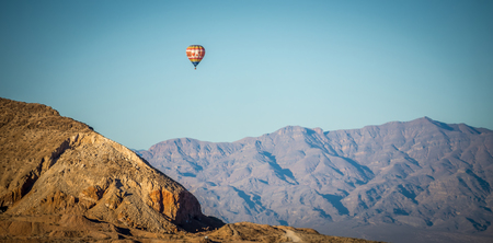 hot air balloon flying above red rock canyonの写真素材