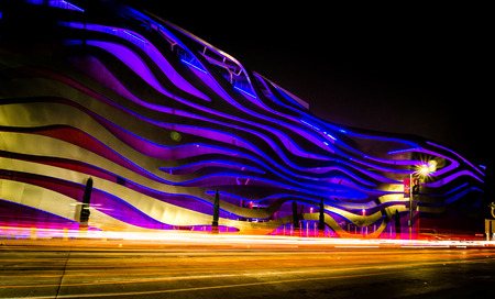Exterior of Petersen Automotive Museum at night in november with car trails
