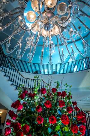 Chandelier hanging over lobby with stair and luxury hallの写真素材