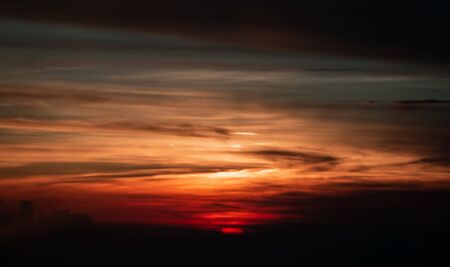 sun setting over clouds views from airplane