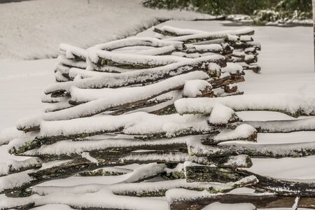 Winter rural landscape with broken fence and treesの写真素材