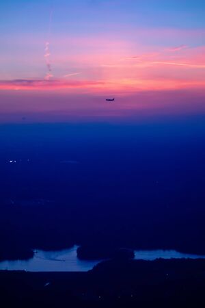 sun setting over clouds views from airplane