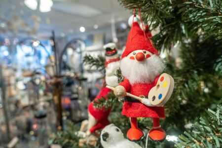 santa clause toy hanging on christmas treeの写真素材