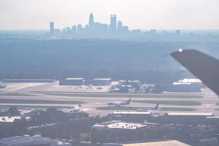 Sun rising early morning over charlotte skyline  seen from airplaneの写真素材