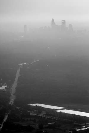 Sun rising early morning over charlotte skyline  seen from airplaneの写真素材