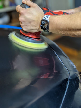 detailing and buffing surface of a luxury automobile