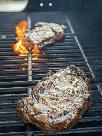 usda premium ribeye steaks on a grillの写真素材