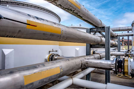 Pipes, tubes, machinery and steam turbine at a power plantの写真素材