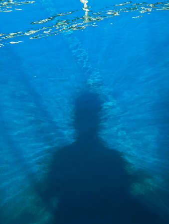 shadow of a person in pool of waterの写真素材