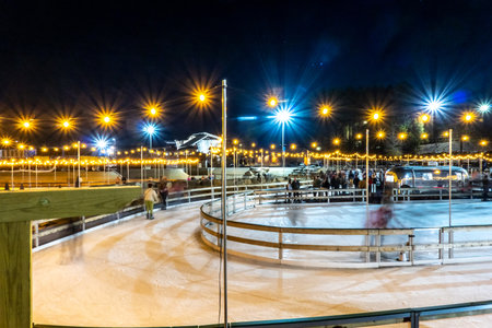 beautiful outdoor ice rink at night with lightsの写真素材