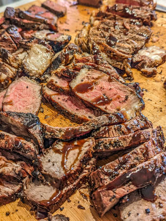 cooked and sliced to perfection 30 day dry aged ny strip beef and bison ribeyeの写真素材