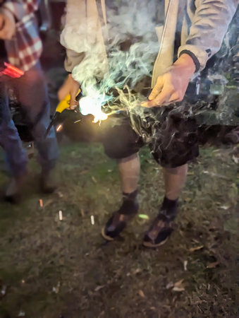 people holding sparklers in hands celebratin a holiday