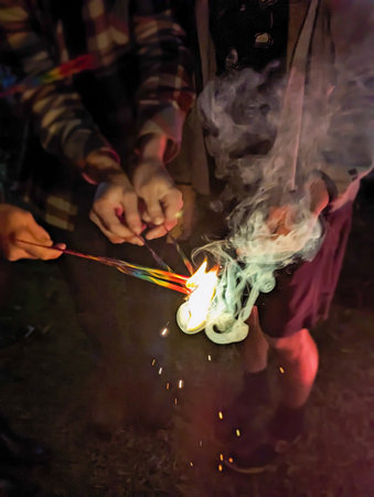 people holding sparklers in hands celebratin a holiday