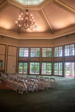 Indoor wedding ceremony with white wedding arch decoratedの写真素材