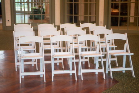 Indoor wedding ceremony with white wedding arch decoratedの写真素材