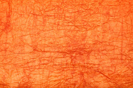 Orange background - crumpled paperの写真素材