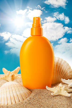 Suntan oil and sea shellsの写真素材