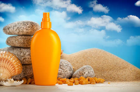 Sunbath - suntan oil on beachの写真素材