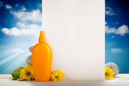 Summer background - blank card, flowers and suntan oilの写真素材