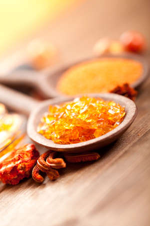 Spa minerals - Orange bath salt on wooden spoonの写真素材