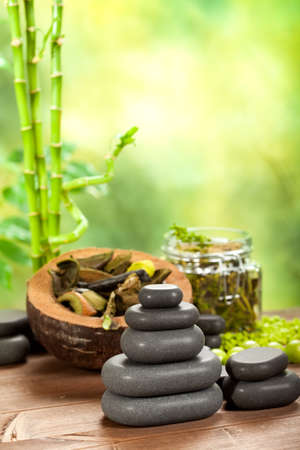 Spa stones on green bamboo backgroundの写真素材