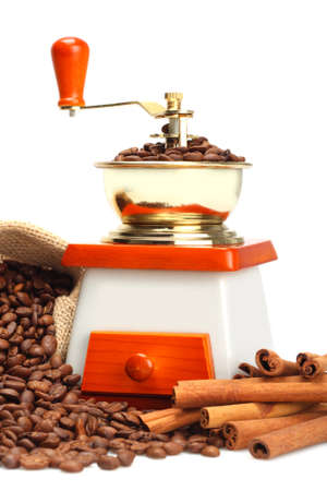 Coffee beans, grinder and cinnamon sticks close upの写真素材