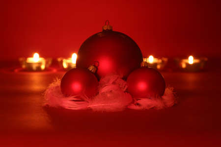 Christmas decoration - red balls, red plumage and christmas lights