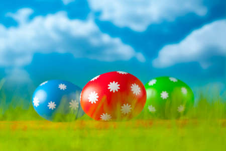 Colored Easter eggs on blue sky backgroundの写真素材