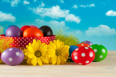 Colored Easter eggs on blue sky background