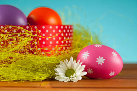 Colored Easter eggs on blue sky background