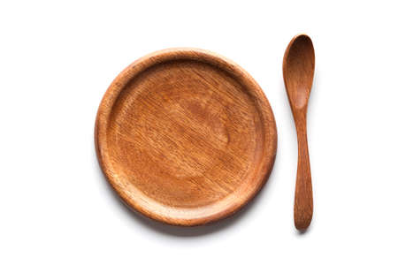 Wooden plate and spoon on white backgroundの写真素材
