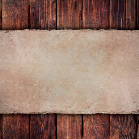 Old handmade paper sheet on wooden backgroundの写真素材