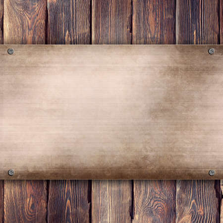 Metal plate on wooden backgroundの写真素材