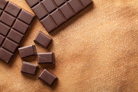 Dark chocolate on old paper backgroundの写真素材