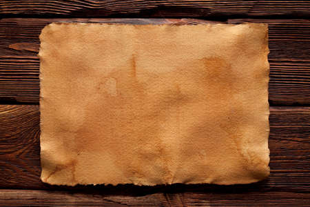 Creased handmade paper on wooden wall backgroundの写真素材