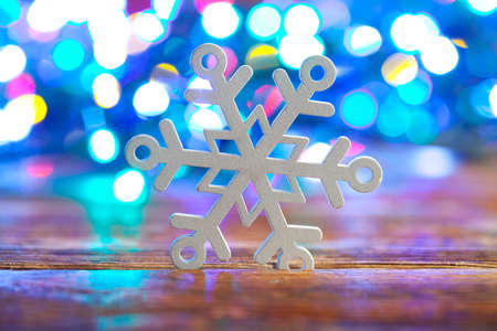 Wooden snowflake on light backgroundの写真素材