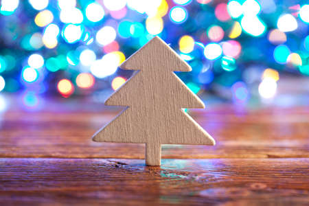 Wooden Christmas tree on lighting backgroundの写真素材