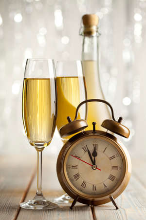 Happy new year - glasses of champagne and alarm clockの写真素材
