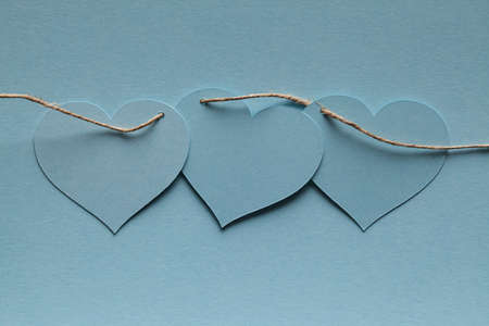 Blue paper hearts on blue backgroundの写真素材