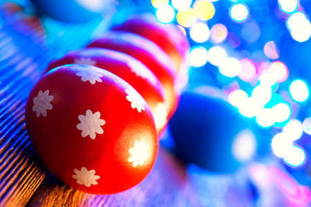 Red Easter eggs on lighting background