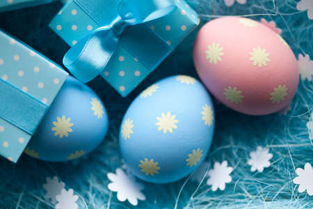 Easter eggs and gift box on blue background
