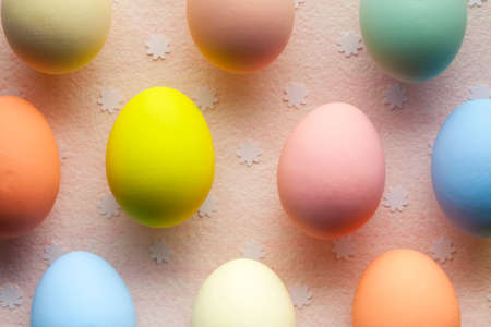 Colored Easter eggs and small flowers in backgroundの写真素材