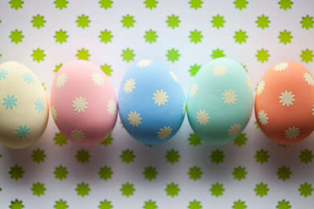 Colored Easter eggs on patterned backgroundの写真素材