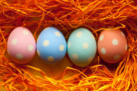 Four colored Easter eggs in the nest