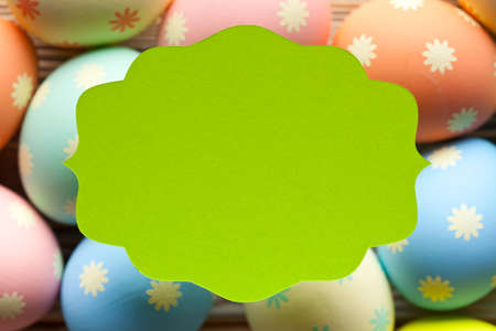 Green label and many colorful eggs in background