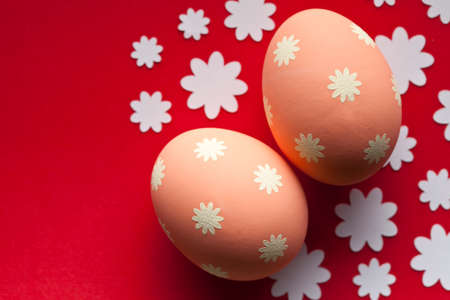 Two orange Easter eggs on red backgroundの写真素材